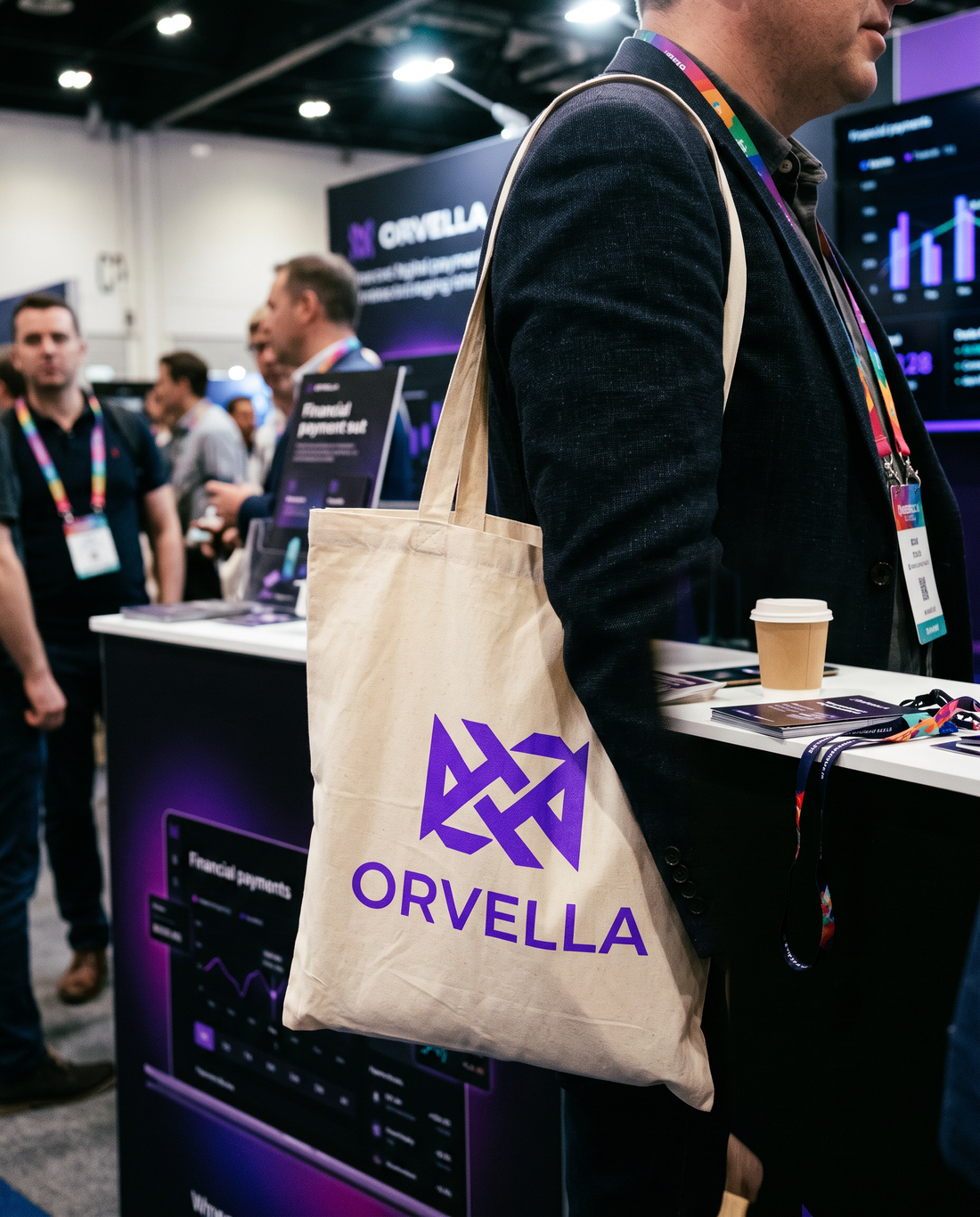 Natural cotton tote bag with a purple fintech logo carried at a conference booth