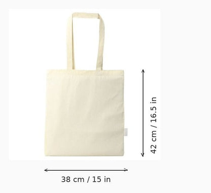 Tote bag en toile blanc cassé avec repères de dimensions indiquant une hauteur de 42 cm (16,5 po) et une largeur de 38 cm (15 po), sur fond blanc
